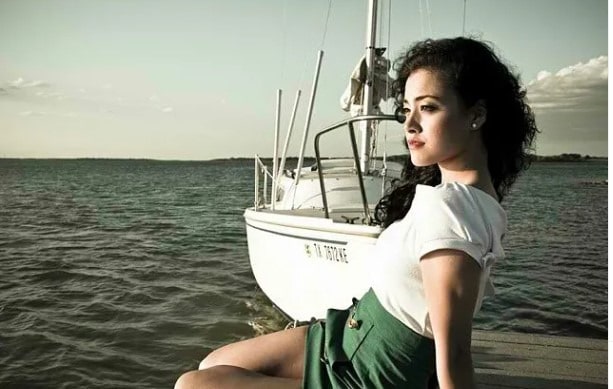 Photoshoot of Yasmine Al-Bustami on a boat somewhere in a sea 